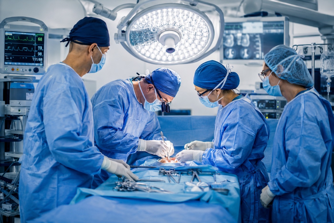A surgical team working at the draped field during a case.